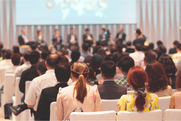 rear-view-of-audience-in-the-conference-hall-or-seminar-meeting-which-have-speakers-on-the-stage.jpg